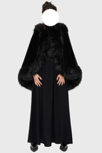 Load image into Gallery viewer, Model wearing a black faux fur-trimmed hooded cloak over a black dress on a white background