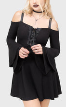 Load image into Gallery viewer, Model wearing a black dress with long sleeves and lace-up front on a white background