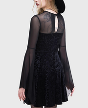 Load image into Gallery viewer, Model wearing a black dress with sheer sleeves and a black hat on a white background