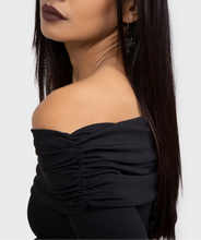 Load image into Gallery viewer, Model wearing a black off-shoulder long sleeve dress against a white background