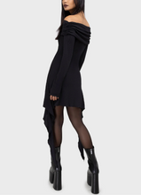 Load image into Gallery viewer, Model wearing a black off-shoulder long sleeve dress against a white background