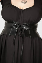 Load image into Gallery viewer, Person wearing black dress with a vegan leather corset belt featuring metal buckles on a plain background