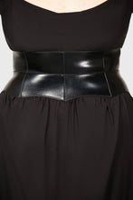 Load image into Gallery viewer, Person wearing black dress with a vegan leather corset belt featuring metal buckles on a plain background