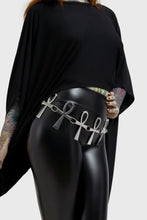 Load image into Gallery viewer, Model wearing a black outfit with a silver belt featuring ankh symbols on a plain background
