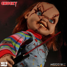 Load image into Gallery viewer, Chucky doll with red hair, striped shirt, and overalls holding an arrow, with 'MDS Mega' and 'MEZCO TOYZ' branding.