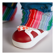 Load image into Gallery viewer, Doll is clothed with good guy overalls, long sleeve shirt and red sneakers. Doll has two black eyes and scars/stitches along face