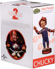 Load image into Gallery viewer, box of Head knocker bobble head of Chucky from Child's Play 2. Chucky has his right hand up, mouth open as if he is yelling, and in his left hand is clutching a knife. Chucky stands on a small round platform that reads "CHUCKY" in red letters on the front.