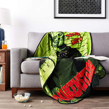 Load image into Gallery viewer, Micro plush fleece throw blanket features the iconic Frankenstein in a mug shot with green background; mirror image on back. Durable stitched-finished edge.