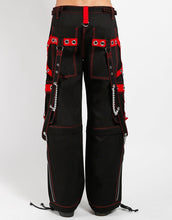 Load image into Gallery viewer, back of Black and red pants feature red stitching, removable straps, adjustable ankles, D-rings, clasps, and deep pockets.