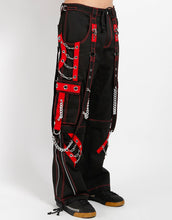Load image into Gallery viewer, side of Black and red pants feature red stitching, removable straps, adjustable ankles, D-rings, clasps, and deep pockets.