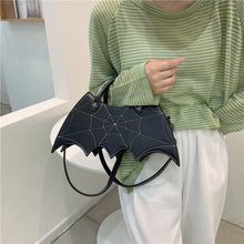 Load image into Gallery viewer, front side of purse showing White stitching spiderweb embroidery on front and hand straps