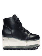 Load image into Gallery viewer, outer view of black vegan leather platform shoe with clear plastic platform. Shoe looks like a sneaker, but is super tall! Clear plastic bottom has a Velcro foot bed opening, to insert toys, candy or fun stuff into the clear bottom of the shoe.