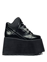 Load image into Gallery viewer, inner view of black vegan leather platform shoe with EVA platform. Shoe looks like a sneaker, but super tall! Shoe has nylon details and mesh lining. Bottom of platform has a "fanned" grip to make the platform more stable.