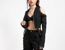 Load image into Gallery viewer, front of Black hoodie with gothic Lolita details. Hoodie has long sleeves that have thumb holes and black lace around the hands. Shoulders are open, and have edges of black on black lace details, as well as silver rivet details around the edge. Front of hoodie zips up, and has black on black lacey lace-up panels on right and left of zipper. Hoodie has black hood.