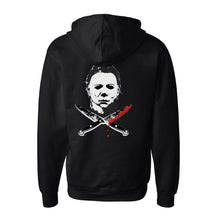 Load image into Gallery viewer, back of Black zip-up hoodie with Michael Myers mask on the back, with two knives crossed underneath. One knife has blood dripping from it. Front left side has a smaller version of the same image. 80% Cotton 20% Polyester.
