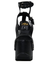 Load image into Gallery viewer, front view of black vegan leather strappy platform sandal with 6.5" heel. Sandal has gunmetal hardware, adjustable ankle strap and adjustable side strap. Bottom of front platform has a fanned grip for better stability.