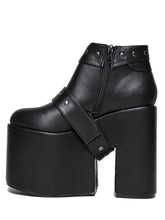 Load image into Gallery viewer, inner side view of black vegan leather super tall 6" heel, 4" platform sleep design boot. Boot has a rivet studded strap that wraps around and is removable or attachable with Velcro. Boot has black EVA platform.