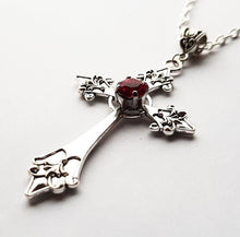 Load image into Gallery viewer, Silver colored zinc alloy vampire cross necklace with red cubic zirconia gem in center of cross.