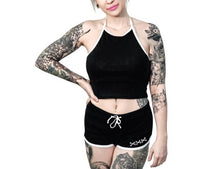 Load image into Gallery viewer, Women's black shorts with whitetrim and white skeleton hand middle finger design on right buttcheek, white drawstring and white cross bones on front left