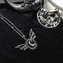 Load image into Gallery viewer, Silver colored zinc alloy bat wing necklace with silver crescent moon in center.