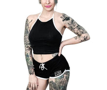Load image into Gallery viewer, Black shorts with white trim and white planchette rose design on both buttcheeks, white drawstring and white spell book design on front left