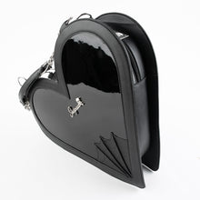 Load image into Gallery viewer, side view of heart shaped glossy black bag with a stitched spiderweb design at the bottom, chain link hardware and faux leather straps.