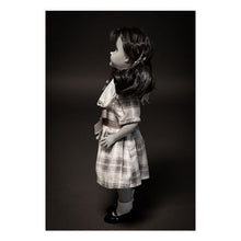 Load image into Gallery viewer, talky tina replica doll with pig tails, wearing a plaid dress with bow around the waist, and black flats with white socks