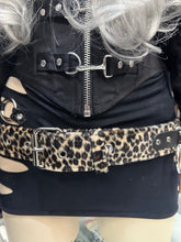 Load image into Gallery viewer, Person wearing a black jacket with a zipper and a leopard print belt.
