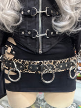 Load image into Gallery viewer, Mannequin wearing a black outfit with leopard print belt and silver rings.
