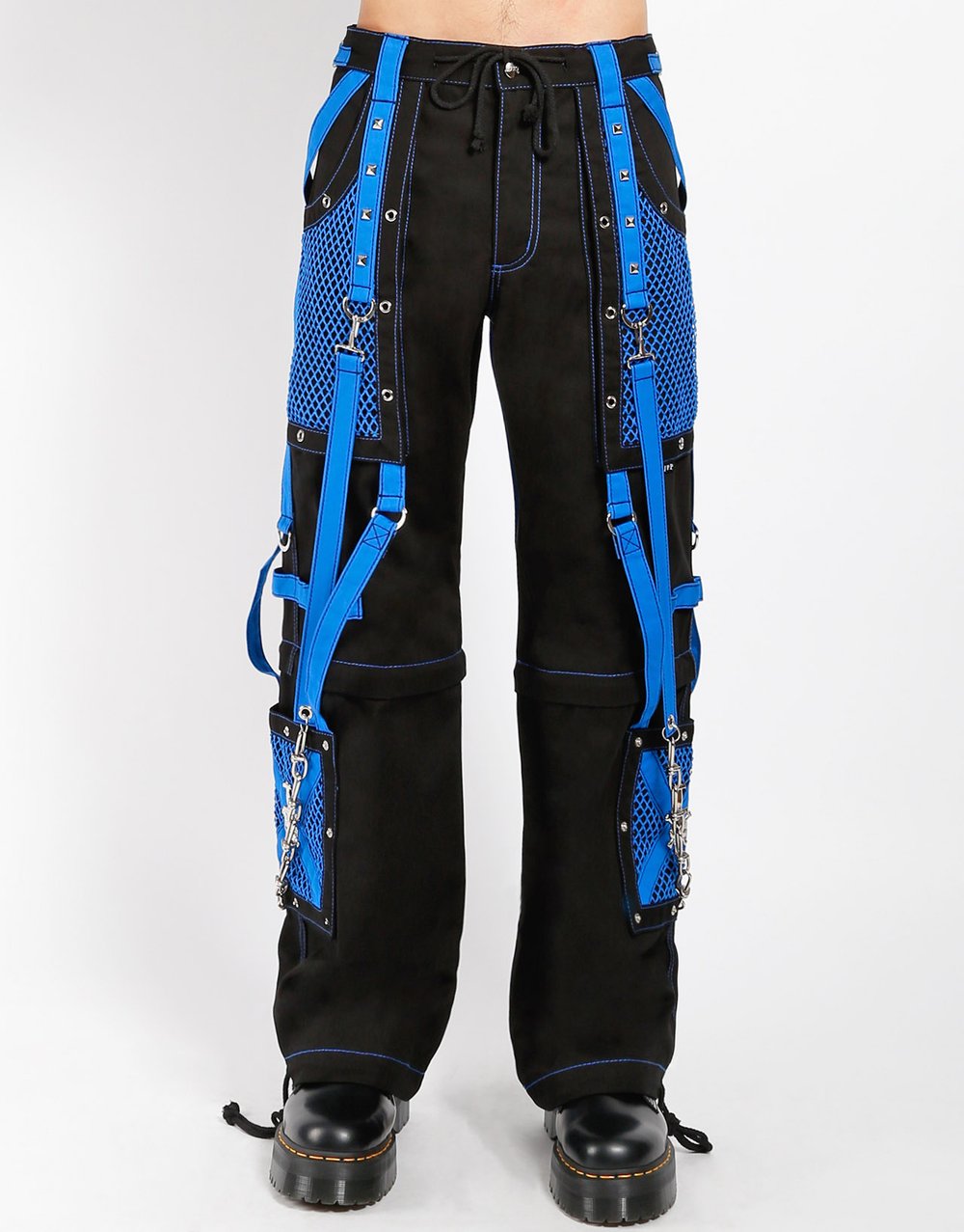 front of Black and blue studded pants zip off into shorts and feature removable chains, adjustable ankles, zippers, D-rings, and deep pockets.