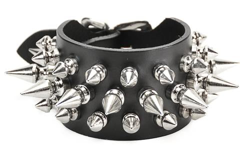 Black leather bracelet with three rows of silver spikes. Top and bottom row consist of 1/2