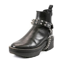 Load image into Gallery viewer, black ankle boot displaying black leather boot strap with two rows of silver tree spikes, single silver o ring and silver hanging chain
