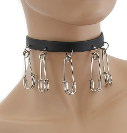 Black leather collar with large silver hanging safety pins.
