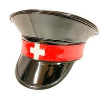 Load image into Gallery viewer, Black shiny patent vegan leather police hat. Front of hat has red strap across the front, with a white cross in the center of the red strap.
