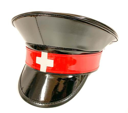 Black shiny patent vegan leather police hat. Front of hat has red strap across the front, with a white cross in the center of the red strap.