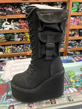 Load image into Gallery viewer, outer side of Women&#39;s black canvas mid-calf platform boot. Full lace up front, with full back zipper. Outside of boot has small pocket with strap.
