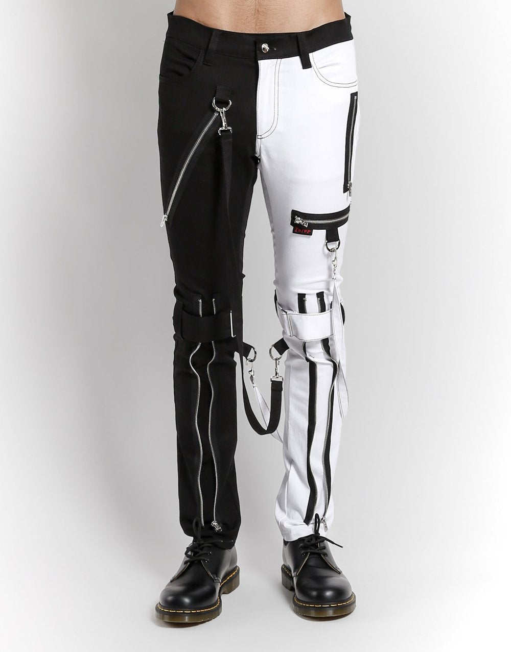front of Classic slim White/Black split leg pants with removable bondage straps and zipper details. Pant legs can be zipped for a change in fit, topped off with a zip fly and button closure.