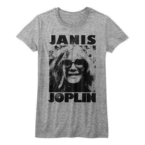 gray janis joplin shirt with logo and picture of janis with big round hippie glasses on, smiling