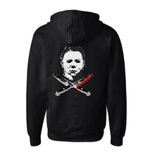 Load image into Gallery viewer, back of Black zip-up hoodie with Michael Myers mask on the back, with two knives crossed underneath. One knife has blood dripping from it. Front left side has a smaller version of the same image. 80% Cotton 20% Polyester.
