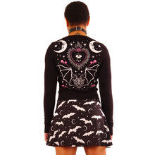 Load image into Gallery viewer, women&#39;s Black long sleeve short cropped cardigan with pink rose designs on outer wrists, white half moon and stars print on top left, and double half moon design on back with eyeball heart and bat
