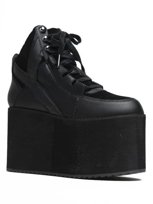 inner view of black vegan leather platform shoe with EVA platform. Shoe looks like a sneaker, but super tall! Shoe has mesh lining.