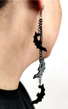 Load image into Gallery viewer, Three silver zinc alloy chains hanging from hook stud. Chains hang at different lengths with an acrylic black see-through bat hanging from each chain.
