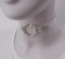 Load image into Gallery viewer, front view of Clear pvc choker with Metal heart at front center and Adjustable buckle closure on back
