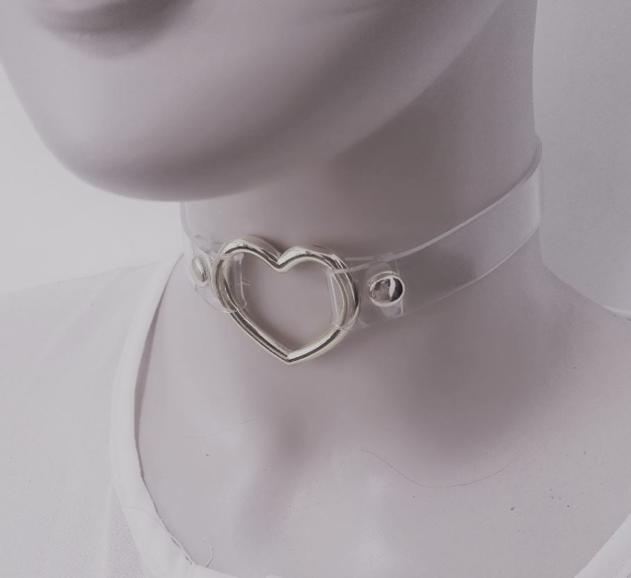 front view of Clear pvc choker with Metal heart at front center and Adjustable buckle closure on back