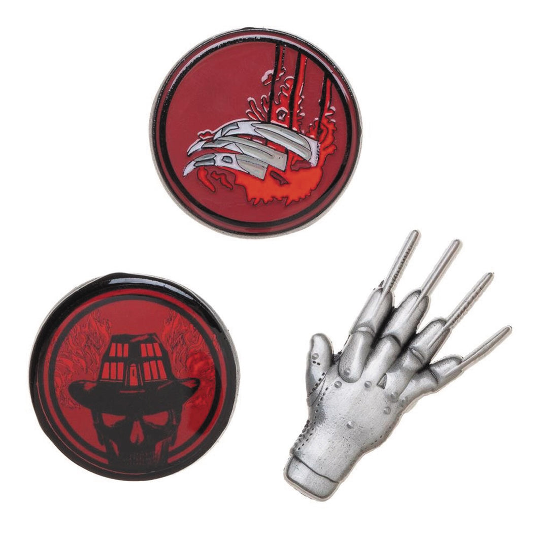 From left to right: circular pin with skeleton freddy krueger, circular pin with bloody knife fingers, metal lapel pin of freddy krueger's glove