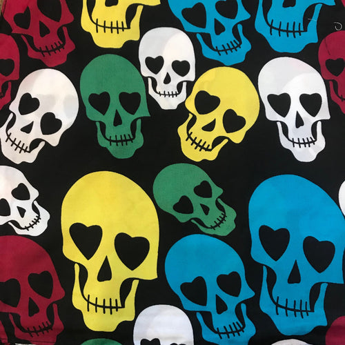 Black bandana with multiple rainbow skulls with hearts in the eyes repeat pattern print. Skulls are white, green, yellow, red and blue.