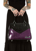 Load image into Gallery viewer, Glossy black vinyl and purple stitched spider webbing, along with contrast purple glitter panel with backseat stitching. Generously sized and can double as an overnight bag, complete with satin leopard liner and signature metal Sourpuss emblem and reinforced studded handles.
