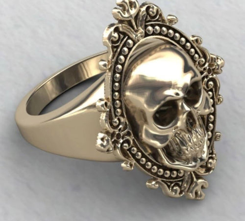 Gold colored zinc alloy skull ring with pretty oval detailed frame around skull.